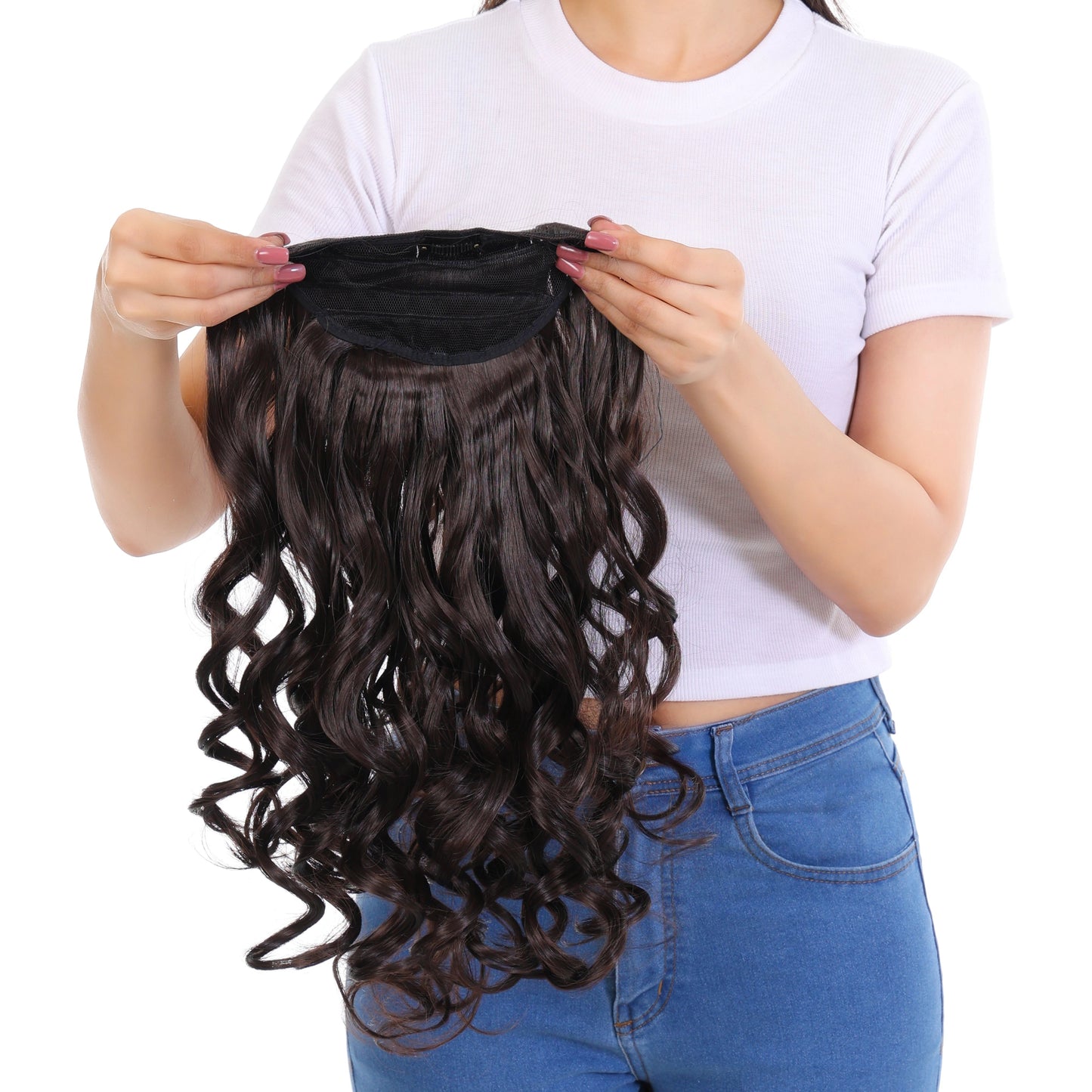 Woman holding a set of wavy hair extensions against a white background